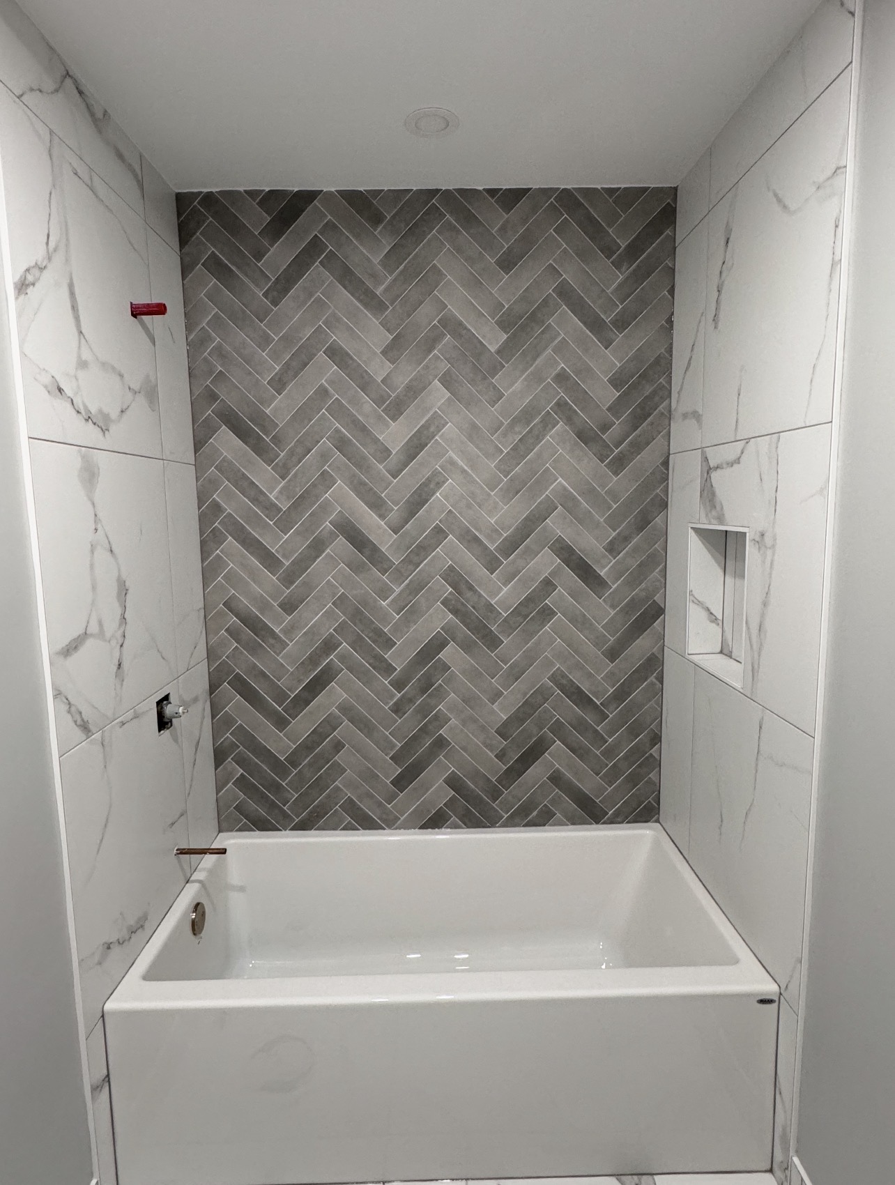 Herringbone bathroom floor tile installation in Ottawa
